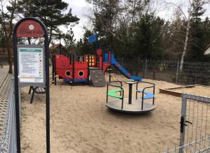 a playground with a play equipment in the sand at Latarnia Morska in Jantar