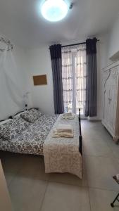 拉斯佩齊亞的住宿－Amici Holidey Camera Stazione，一间卧室设有一张床和两个窗户。