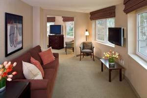 a living room with a couch and a tv at Silver Cloud Hotel - Seattle Broadway in Seattle