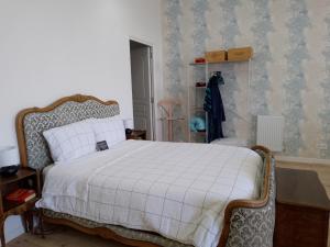 a bedroom with a bed with a white comforter at Pyrenees Vue Gite - Vues Fantastique, Parking Gratuit Sur Place & Piscine in Saint-Gaudens +22 photos