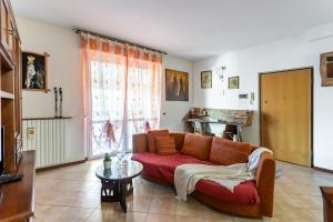 a living room with a couch and a table at Lilly House - Travacò Siccomario - by HOST4U in San Martino Siccomario