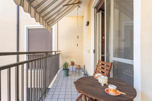 a wooden table on the balcony of a house at Lilly House - Travacò Siccomario - by HOST4U in San Martino Siccomario +15 photos