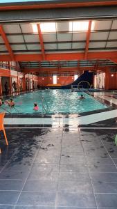 a group of people swimming in a large swimming pool at 3 Bedroom caravan St osyth beach holiday park with free WiFi and parking in Great Clacton