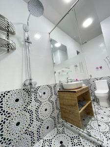 a bathroom with a shower and a sink and a toilet at Meros Hotel in Bukhara