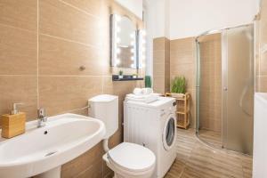 a bathroom with a toilet and a sink and a shower at Full comfort, 4 bedrooms in the heart of the city in Budapest