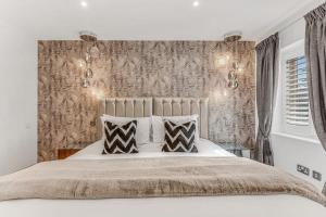 a bedroom with a large bed with two pillows at Foxglove House in Loughborough