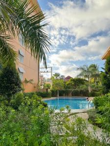 a swimming pool in front of a building at 2 Bedroom and 1 Bedroom Apartments with Private Pool and Gym in Puerto Princesa City