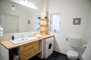 a bathroom with a sink and a washing machine at Stylish and comfy apartment for 6 guests in Budapest