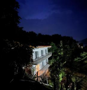 a building at night with trees in the foreground at Orsova Gratca 164 in Orşova