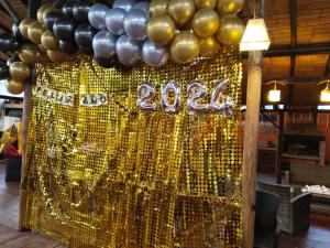 uma exibição de balões dourados e pretos e um sinal em casa Hotel la Tranquera em Villa de Leyva