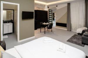 a living room with a bed and a dining room at Cute, new and stylish apartment in the center in Budapest