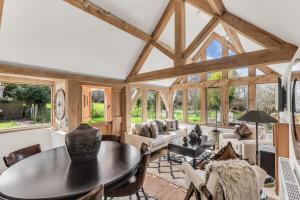 a large living room with a table and chairs at Honeysuckle Cottage - Hot Tub Packages Available in Weston Subedge