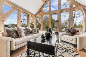 a living room with two couches and a table at Honeysuckle Cottage - Hot Tub Packages Available in Weston Subedge