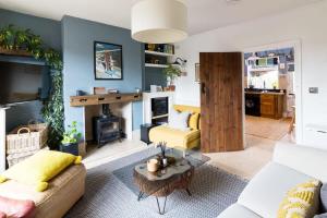 a living room with a couch and a fireplace at Hygge House Cosy 3 Bedroom 2 Bathroom Townhouse in Kegworth