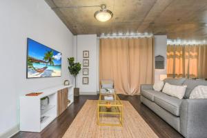 ein Wohnzimmer mit einem Sofa und einem Tisch in der Unterkunft The perfect gateway with magical views in DT ORL in Orlando