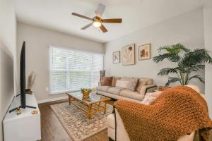 a living room with a couch and a ceiling fan at Cozy retreat getaway Family-sized By Lake Eola in Orlando