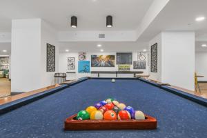 a pool table with a bunch of balls on it at Trendy Gateway by Lake Eola Free Parking in Orlando
