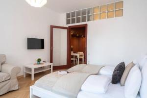 a living room with a bed and a couch at Convenient apartment in the heart of downtown in Budapest