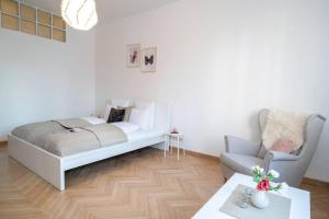 a bedroom with a bed and a chair and a table at Convenient apartment in the heart of downtown in Budapest