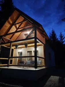 a view of a house with a large window at Woodland house ** in Sântimbru-Băi