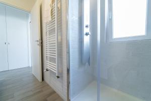 a shower with a glass door in a bathroom at Fronte mare in Polignano a Mare