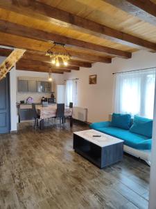 a living room with a blue couch and a table at Woodland house ** in Sântimbru-Băi