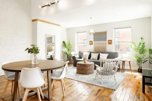 a living room with a table and a couch at Soaring 2BR Parkside Loft Walkable to it All in Cincinnati