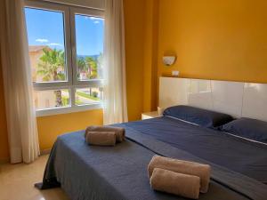 a bedroom with a bed with two towels on it at BRISA DEL MAR - 200m to the beach in Oliva