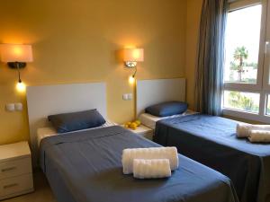 a room with two beds and a window at BRISA DEL MAR - 200m to the beach in Oliva +36 photos