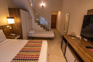 Cama ou camas em um quarto em Amora Hotel Maresias