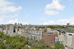 an aerial view of a city with tall buildings at Amazing panoramic view facing Parc de La Villette - Apartment 4P in Paris