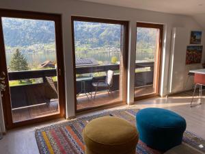 a living room with a view of a lake at Villa Bellevue Apartment 1 Deluxe Apartment in Ossiach +12 photos