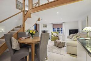 a dining room and living room with a table and chairs at Squirrel Lodge - 2 Bed Country Home in Market Harborough