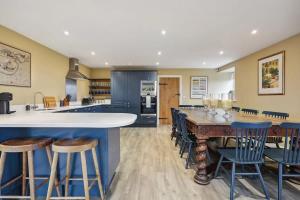 a large kitchen with a large table and chairs at Sophie's Barn - Hot Tub Packages Available in Market Harborough