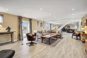 a living room with a couch and a table at Sophie's Barn - Hot Tub Packages Available in Market Harborough