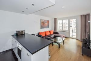 a kitchen and living room with a couch and a table at Apartment Centro in Berlin