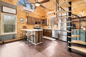 a kitchen with a spiral staircase in a log cabin at Redwoods Rising - Sweeping Views-Hot Tub in West Fork