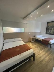 a bedroom with two beds in a room at Apartamento duplex exclusivo- Linda Sofia Belle in Santa Fe de Antioquia +14 photos