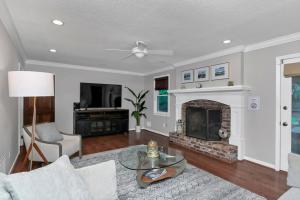 a living room with a couch and a fireplace at The Quails Nest of Harbison in Columbia