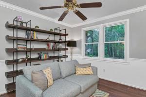 uma sala de estar com um sofá e uma ventoinha de tecto em The Quails Nest of Harbison em Columbia