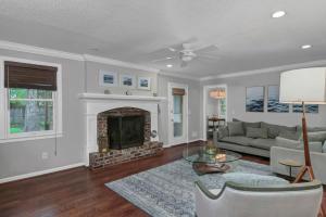 a living room with a couch and a fireplace at The Quails Nest of Harbison in Columbia