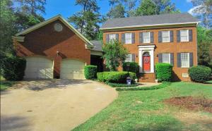 a brick house with a red door and a driveway at Serenity in the Suburbs in Columbia