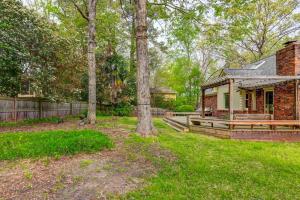 a home with a brick house and trees at The Quails Nest of Harbison in Columbia