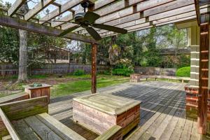 a patio with benches and a wooden pergola at The Quails Nest of Harbison in Columbia