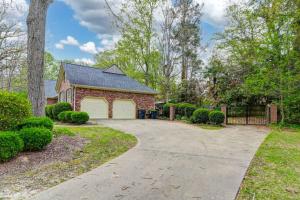 a brick house with a garage and a driveway at The Quails Nest of Harbison in Columbia