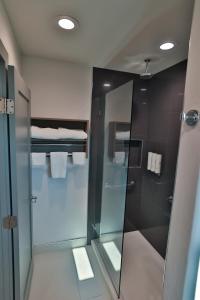 a bathroom with a shower with a glass door at Hotel Miramar in San Clemente