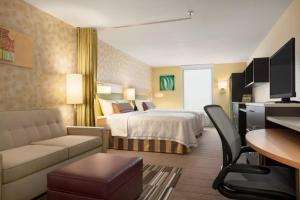 ローウェイにあるHome2 Suites by Hilton Rahwayのベッドとソファ付きのホテルルーム