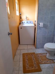 a bathroom with a toilet and a sink at Faith & Peace Guest House in Fontenoy