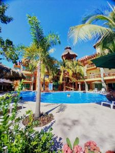 a resort with a swimming pool and palm trees at Villas Dulce Suenos in Rincon de Guayabitos