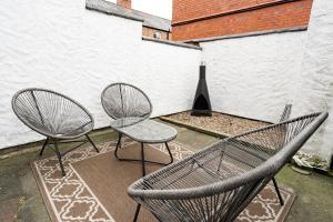 two chairs and a table on a patio at Great 3 bed Handbridge home - Sleeps 6 - EV Charger in Hough Green